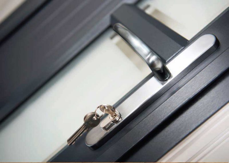 close up of key in lock on silver door handle for black uPVC Doors in Dorset